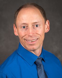 portrait photo of Dr. Steven Barczi in blue dress shirt and tie