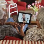 Elderly African American couple video chat with a doctor on a tablet